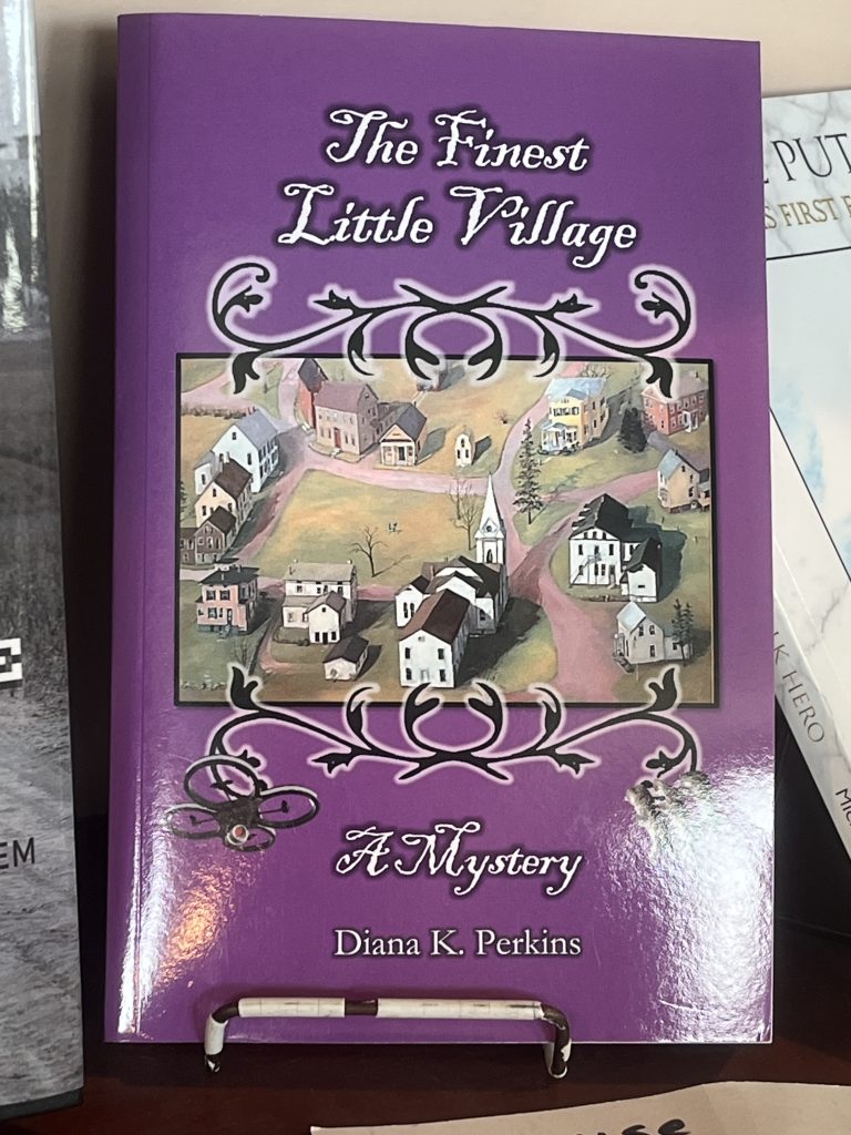 A picture of the book "The Finest Little Village" by local author, Diana Perkins.