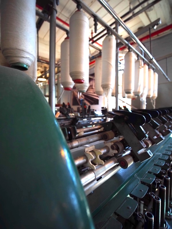 A view of a ring spinning frame in the Windham Textile and History Museum's Dugan Hall industrial exhibit space.