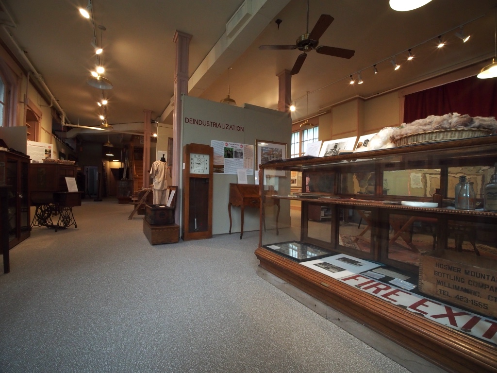 A view of the Thread City exhibit showing a display case and various artifacts.