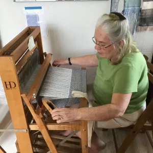 Master Weaver Peggy Church operating a loom